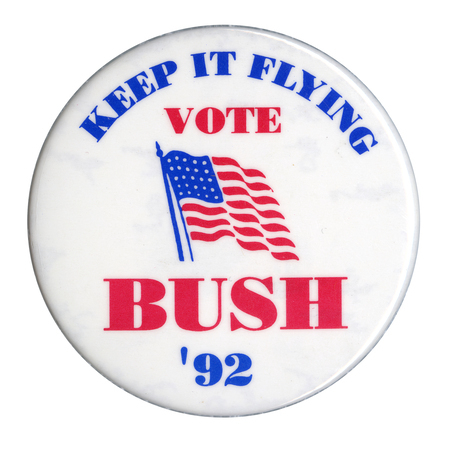 Round, white button with a drawing of the US flag and blue and red text reading "KEEP IT FLYING VOTE BUSH '92"