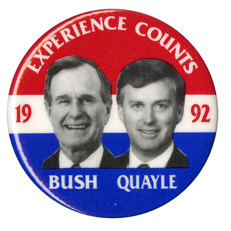 Round button with red, white, and blue horizontal bands and black and white photographs of George H. W. Bush and Dan Quayle. White and red text reads "EXPERIENCE COUNTS 1992 BUSH QUAYLE"