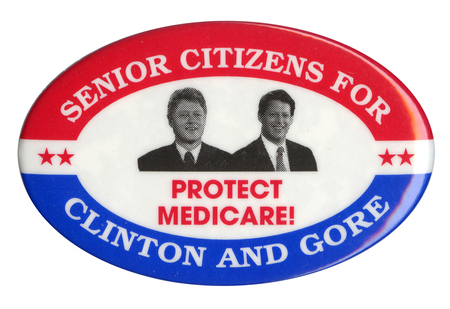 Oval button with a red and blue border and a black and white photograph of Bill Clinton and Al Gore in the center. White and red text reads "SENIOR CITIZENS FOR CLINTON AND GORE PROTECT MEDICARE!"