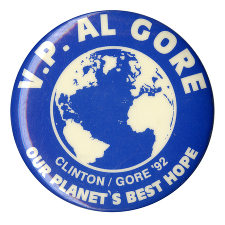 Round, blue button with a white and blue depiction of the globe and white text reading "V. P. AL GORE CLINTON/GORE '92 OUR PLANET'S BEST HOPE"