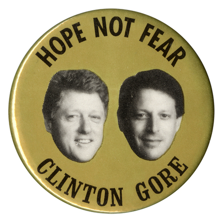 Round, gold button with black and white photographs of Bill Clinton and Al Gore. Black text reads "HOPE NOT FEAR CLINTON GORE"