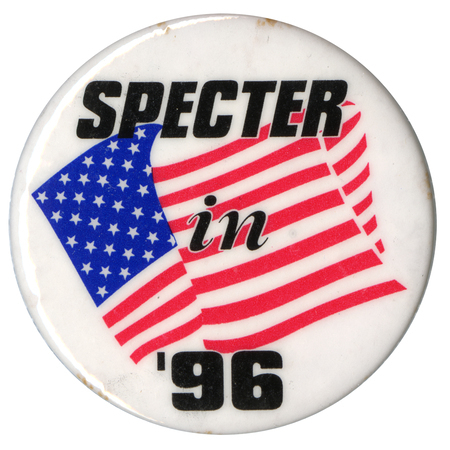 Round, white button with a red, white, and blue drawing of a US flag. Black text reads "SPECTER in '96"