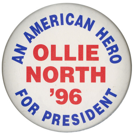 Round, white button with blue and red text reading "AN AMERICAN HERO FOR PRESIDENT OLLIE NORTH '96"