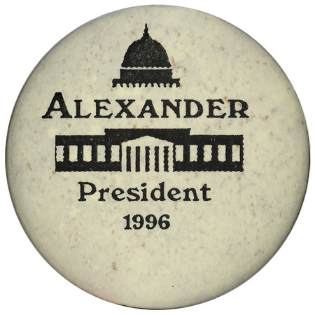 Round, white button with a black drawing of the US Capitol and black text reading "ALEXANDER President 1996"