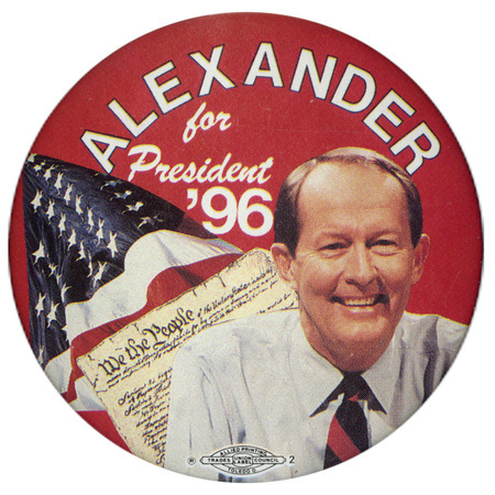 Round, red button with a color photograph of Lamar Alexander, the US Constitution, and the US flag. White text reads "ALEXANDER for President '96"