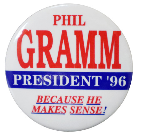Round, white button with red and blue text reading "PHIL GRAMM PRESIDENT '96 BECAUSE HE MAKES SENSE!"