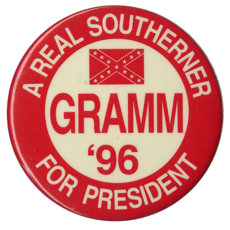 Round, red and white button with a red drawing of the Confederate flag. White and red text reads "A REAL SOUTHERNER GRAMM '96 FOR PRESIDENT"