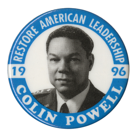 Round, white button with blue border and a black and white photograph of Colin Powell in the center. White and blue text reads "RESTORE AMERICAN LEADERSHIP COLIN POWELL 1996"