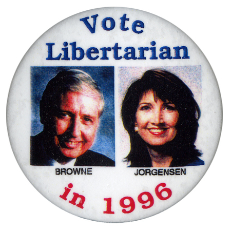 Round, white button with color photographs of Harry Browne and Jo Jorgensen, each with their last name underneath their photo. Blue and red text reads "Vote Libertarian in 1996"