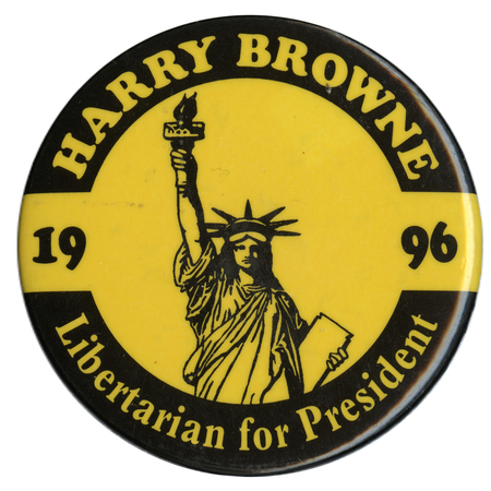 Round, yellow button with a black border and a black drawing of the Statue of Liberty. Yellow and black text reads "HARRY BROWNE Libertarian for President 1996"
