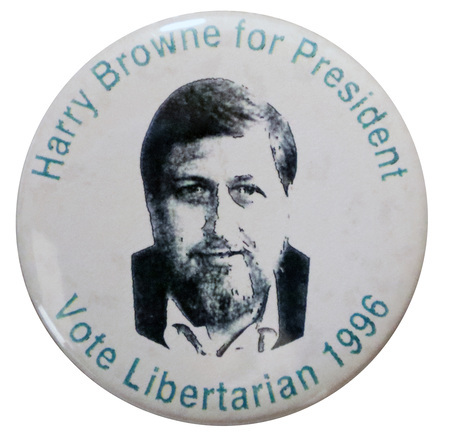 Round, white button with a black and white photograph of Harry Browne. Green text around the edge of the button reads "Harry Browne for President Vote Libertarian 1996"