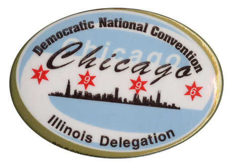 Oval button with a gold border and a blue, black, and white drawing of the Chicago skyline. In four red stars are the numbers "1996". Black text reads "Democratic National Convention Chicago Illinois Delegation"