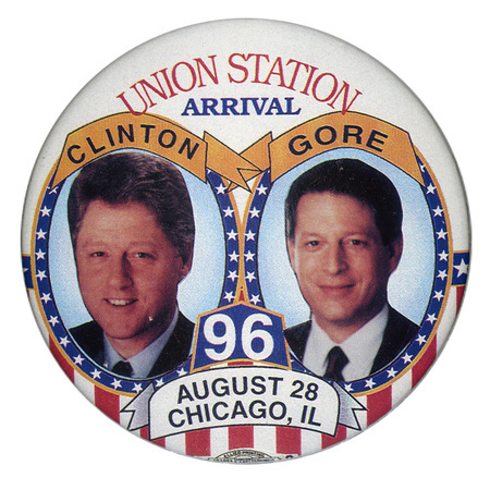 Round, white button with red, white, and blue stars and stripes decorations. Two circles contain color photographs of Bill Clinton and Al Gore, each with his last name above his face. Red, white, blue, and black text reads "UNION STATION ARRIVAL 96 AUGUST 28 CHICAGO, IL"