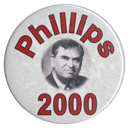 Round, white button with a black and white photograph of Howard Phillips. Red text reads "Phillips 2000"