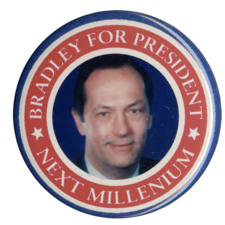 Round button with a blue and red border around a color photograph of Bill Bradley. White text reads "BRADLEY FOR PRESIDENT NEXT MILLENNIUM"