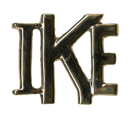 Silver pin in the shape of the letters "IKE"