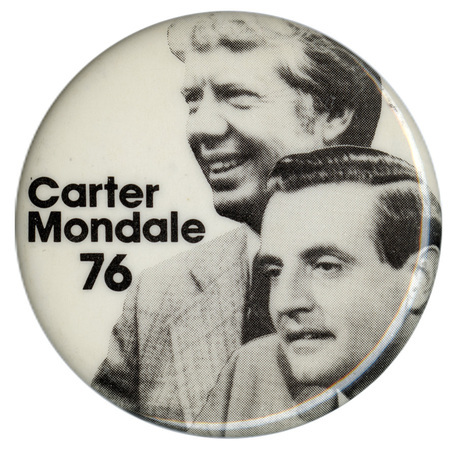 Round, white pin with black and white photographs of Jimmy Carter and Walter Mondale. Black text reads "Carter Mondale 76"