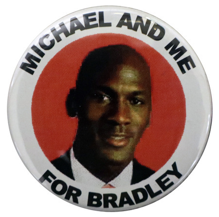 Round button with a white border. In the center is a color photograph of Michael Jordan against a red background. Black text reads "MICHAEL AND ME FOR BRADLEY"