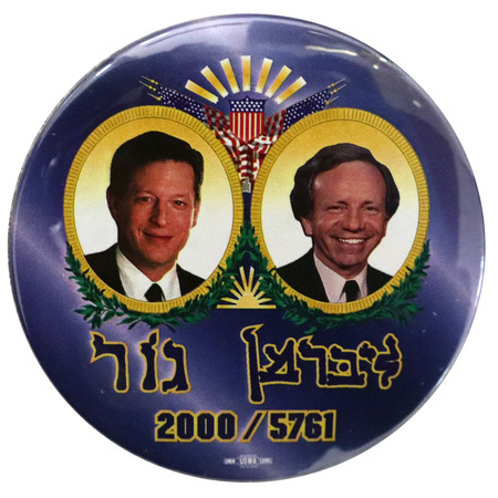Round, blue button with color photographs of Al Gore and Joe Lieberman in an elaborate red, blue, and gold frame. Blue text reads "Gore Lieberman" in Hebrew and "2000/5761"