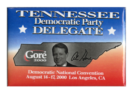 Rectangular, blue and red button with a black and white photograph of Al Gore inside an outline of the state of Tennessee. White text reads "TENNESSEE Democratic Party DELEGATE Gore 2000 Democratic National Convention August 14-17, 2000 Los Angeles, CA"