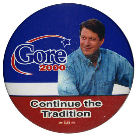 Round, blue, white, and red button with a color photograph of Al Gore. Blue and red button reads "Gore 2000 Continue the Tradition"