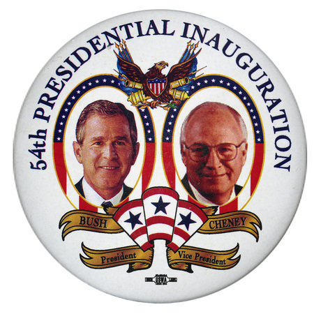 Round, white button with color photographs of George W. Bush and Dick Cheney among illustrations of an eagle, cannons, flags, and red, white, blue, and gold ribbons. Blue text reads "54th PRESIDENTIAL INAUGURATION BUSH CHENEY President Vice President"