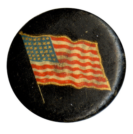 Round, black button with a color illustration of the US flag.