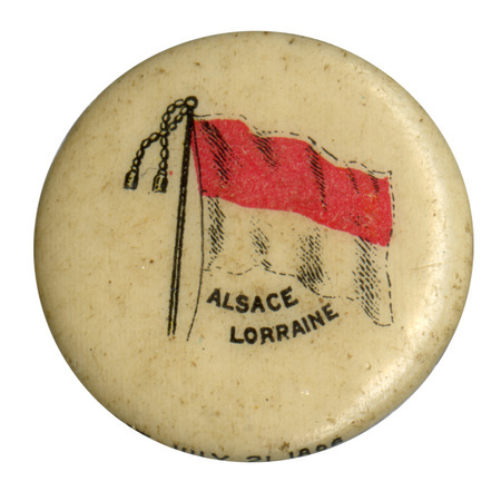 Round, white button with a color illustration of the flag of Alsace, horizontally split into a red upper half and white lower half. Black text reads "ALSACE LORRAINE"