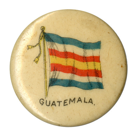 Round, white button with a color illustration of the 19th century flag of Guatemala, horizontal bands of blue, white, red, and yellow. Black text at the bottom reads "GUATEMALA."