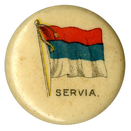 Round, white button with a color illustration of the flag of Serbia, horizontal red, blue, and white bands. Black text at the bottom reads "SERVIA."