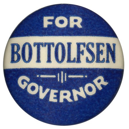 Round, blue button with a horizontal white band. White and blue text reads "FOR BOTTOLFSEN GOVERNOR"