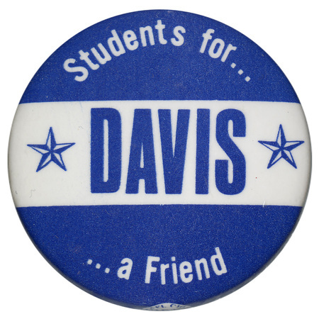 Round, blue button with a white horizontal band and white and blue text reading "Students for... DAVIS ...a Friend"