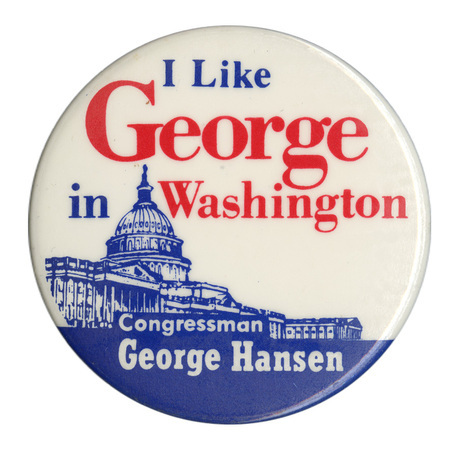 Round, white button with a blue illustration of the US Capitol. Blue, red, and white text reads "I Like George in Washington Congressman George Hansen." The words "George" and "Washington" are highlighted in red. 