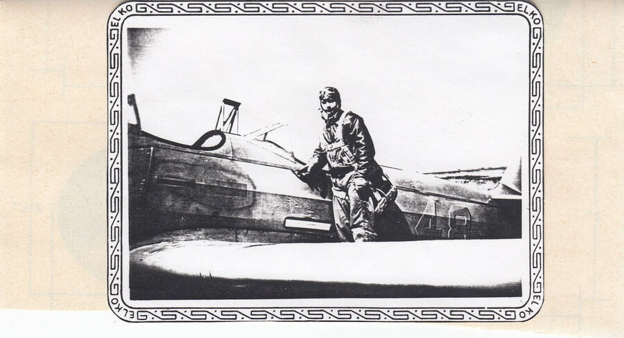 Photograph of Calnon in pilot suit outside training plane.