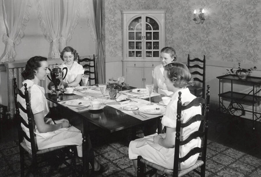 1932 photograph of Home Management House. Four students at a dining table. [PG1_106-02]