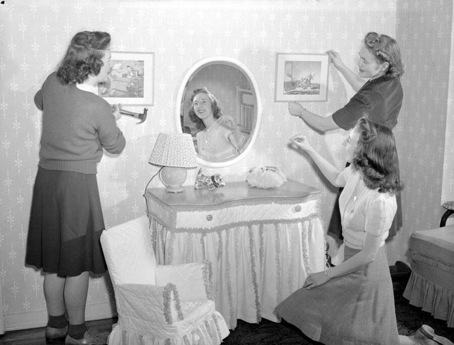 January 27, 1942 photograph of the Home Management House. Carmelita Guernsey, Winifred Hart, and Margaret Wilson decorating. [PG1_106-06]