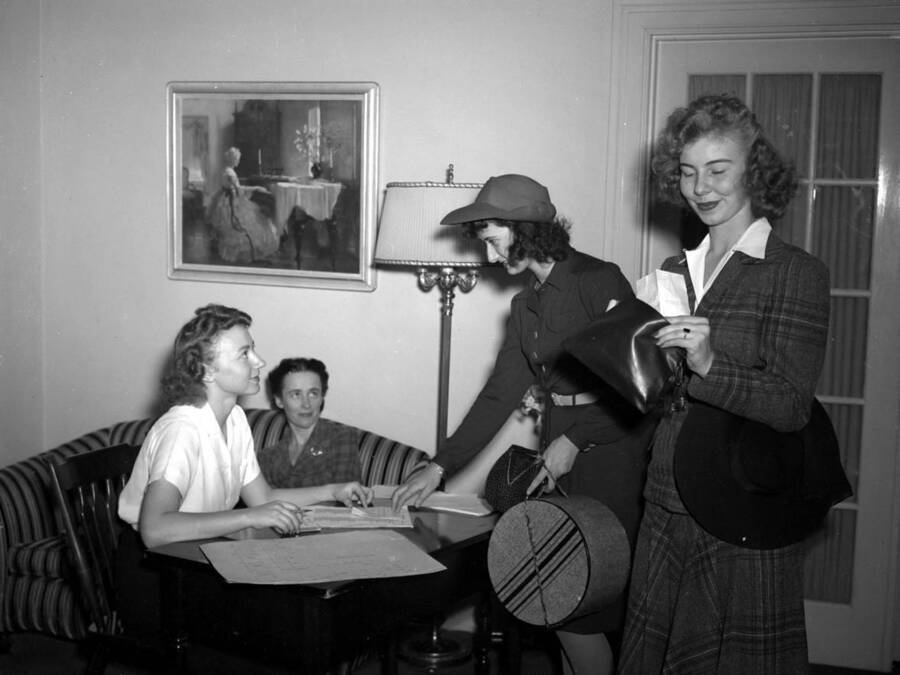 1942 photograph of the Home Management House. Several women in foreground. [PG1_106-07]