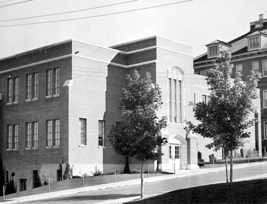 1943 photograph of the Dairy Science Building. Morill Hall in background, trees in foreground. [PG1_108-03]