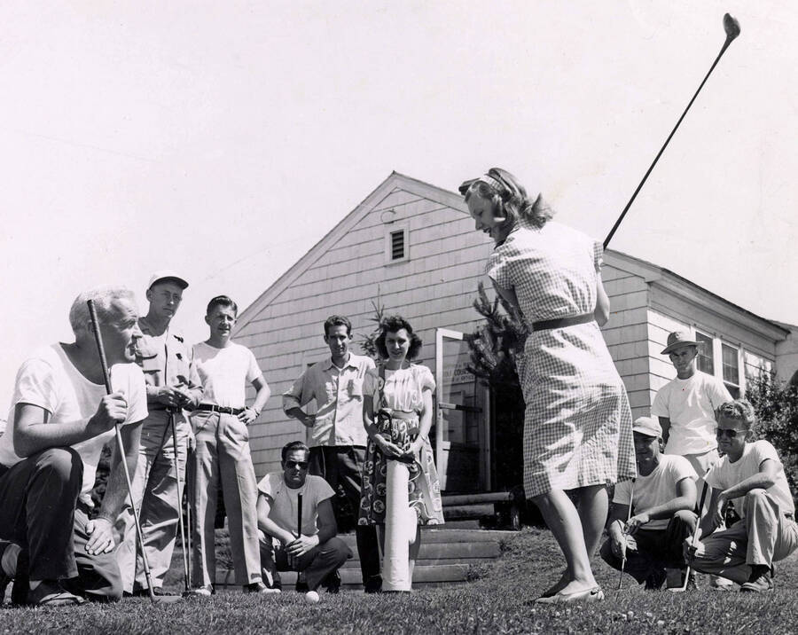 1950 photograph of the Golf Course. A group of students are learning how to play. [PG1_110-03]