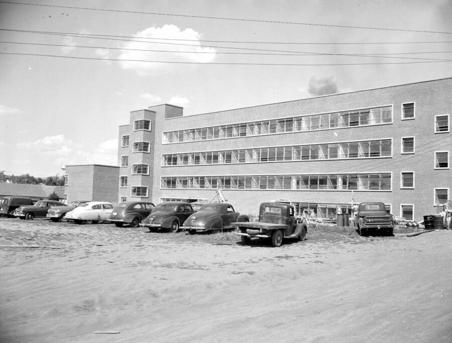 July 25, 1950 photograph of the Agricultural Science Building under construction. Automobiles in foreground. . [PG1_111-23a]