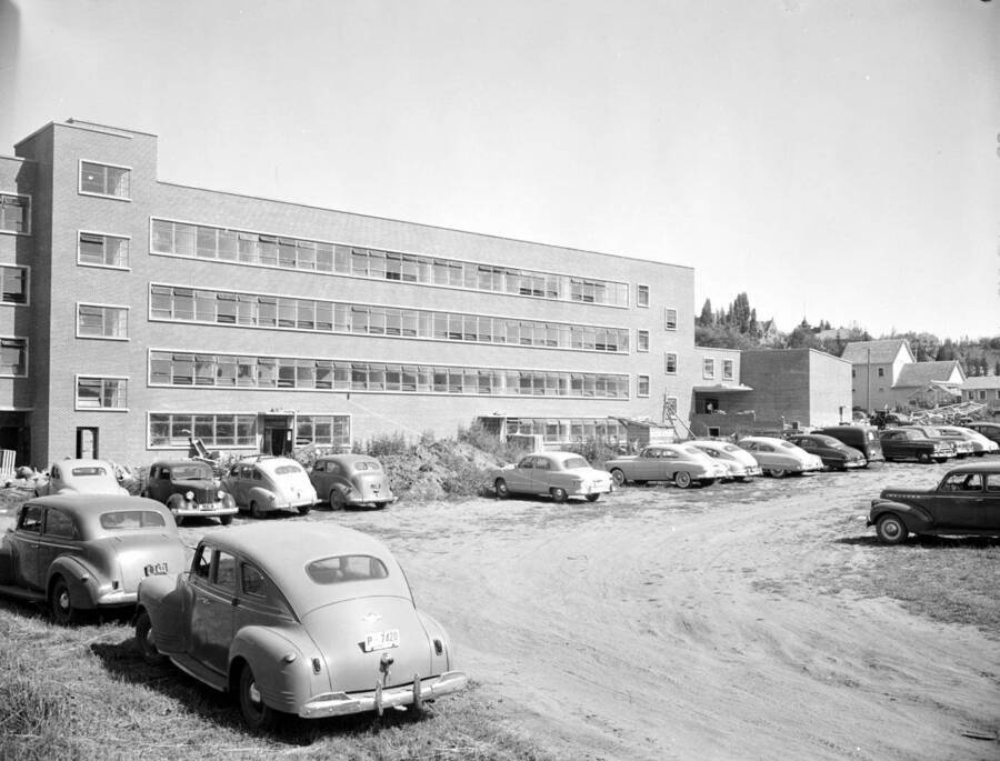 July 25, 1950 photograph of the Agricultural Science Building under construction. Automobiles in foreground. [PG1_111-23b]