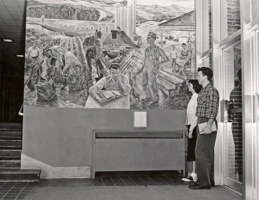 1950 photograph of Agricultural Science Building. Students view a mural. [PG1_111-04]