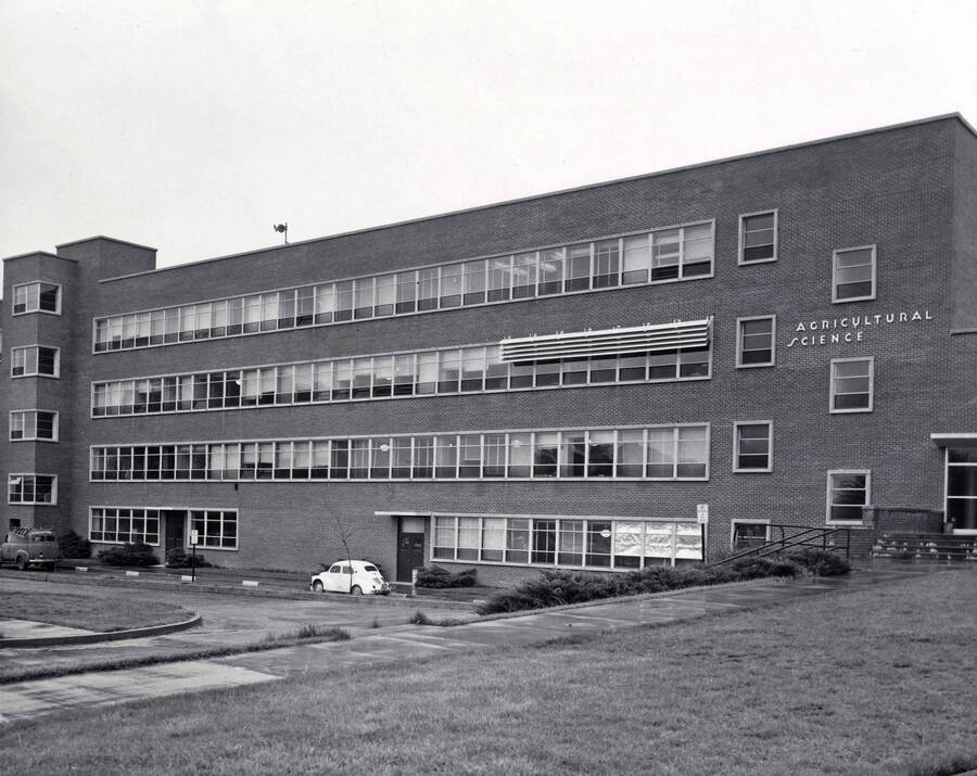 1955 photograph of Agricultural Science Building. Automobiles next to building. Donor: Publications Dept.. [PG1_111-08a]