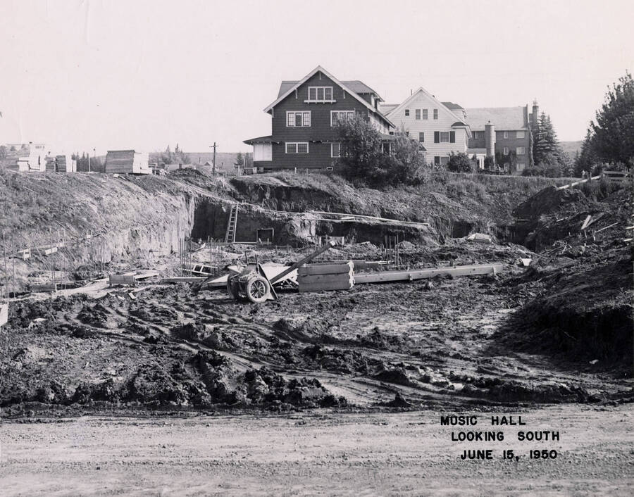 June 15, 1950 photograph of the Music Building under construction. Houses in the background. [PG1_117-14a]