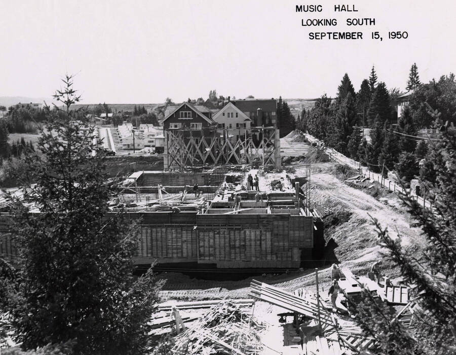 September 15, 1950 photograph of the Music Building under construction. Houses in the background. [PG1_117-17a]