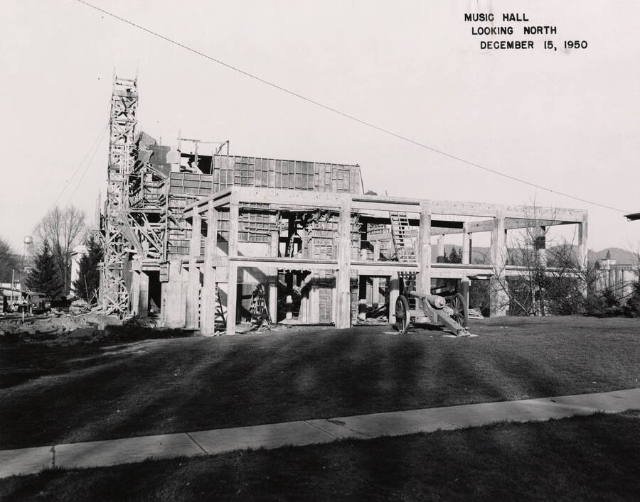 December 15, 1950 photograph of the Music Building under construction. Cannon in foreground. [PG1_117-20a]