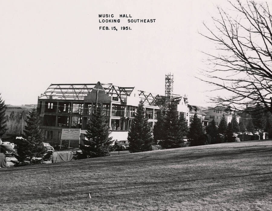 February 15, 1951 photograph of the Music Building under construction. Automobiles in foreground. [PG1_117-22a]