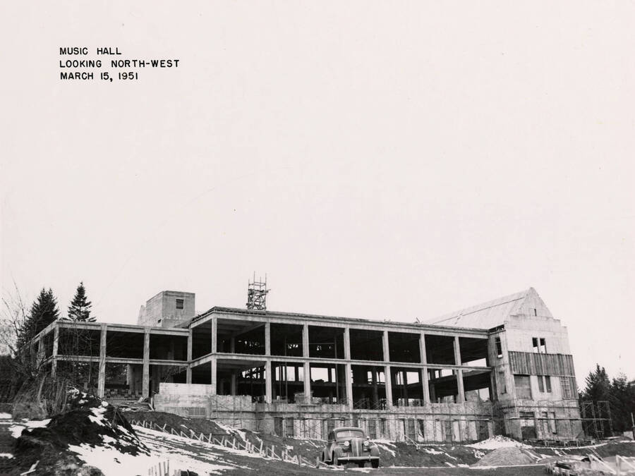 March 15. 1951 photograph of the Music Building under construction. Automobile in the foreground. [PG1_117-23b]