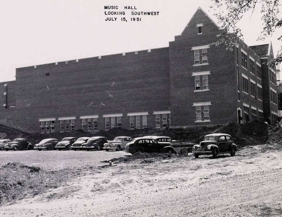 July 15, 1951 photograph of the Music Building under construction. Automobiles in foreground. [PG1_117-26b]