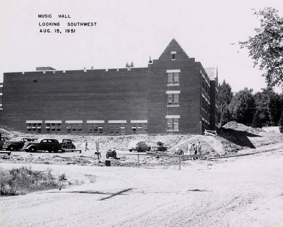 August 15, 1951 photograph of the Music Building under construction. Automobiles in foreground. [PG1_117-27a]